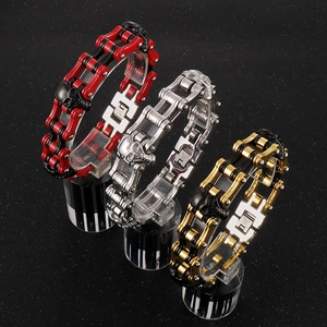 Three heavy stainless steel biker bracelets with skull motifs in red, silver, and gold colors