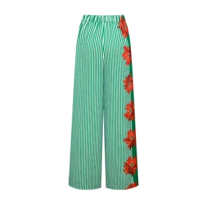 Detail of high-waisted striped wide-leg pants with large red floral print and side panels
