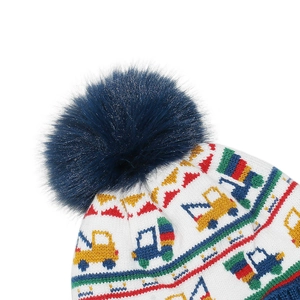 Detail of knit winter hat featuring colorful truck patterns and a fluffy blue faux fur pom