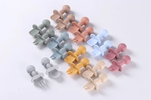 Close-up of baby silicone fork and spoon set in various Morandi colors with safety guards