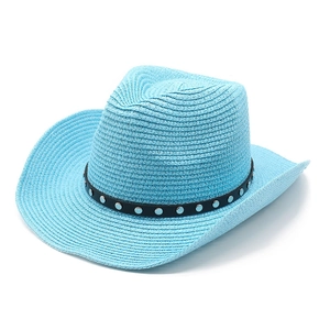 Detailed texture of blue straw cowboy hat with black studded band and curved brim