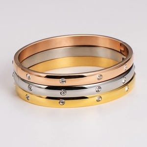 Polished stainless steel bangle set with zircons in gold, silver, and rose gold finishes