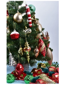 Close-up of a festive Christmas tree adorned with colorful ornaments and mixed baubles