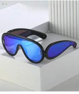 Detail of futuristic oversized blue mirrored sunglasses with black frames and silver accents