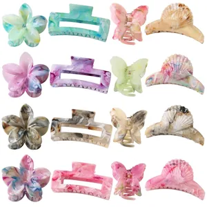 Various acetate hair claws in butterfly, flower, and shell shapes with marble patterns