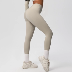 Detail of high-waisted seamless yoga leggings in beige showing elastic fabric texture