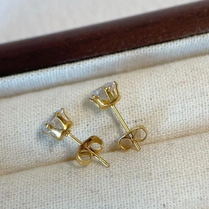 Detail of 18k gold plated stud earrings with six-prong set brilliant round zircon stones