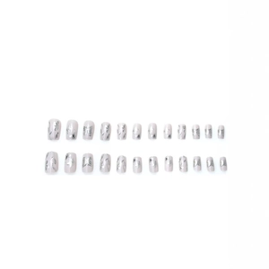 Short square press-on nails in nude pink with silver butterfly and floral patterns