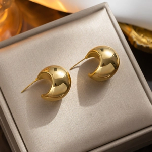 Minimalist gold moon-shaped stud earrings made of titanium steel in a luxury jewelry box