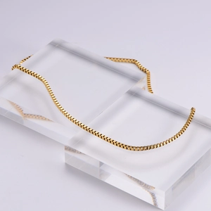 Detailed view of an 18k gold-plated stainless steel box chain necklace with elegant metallic luster