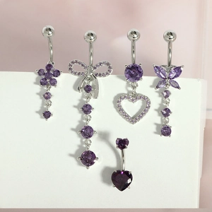 Detail view of silver navel rings set with purple cubic zirconia in various styles