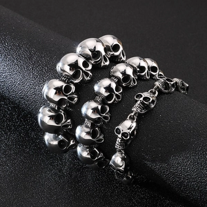 Macro detail of gothic stainless steel skull bracelets with polished silver finish