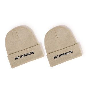Two khaki NOT INTERESTED embroidered beanies in soft knit wool for men and women