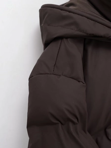 Detailed view of the dark brown thick quilted puffer coat featuring high-quality matte fabric