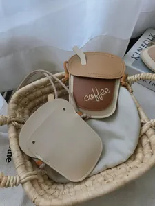 Close-up of cute PU leather coffee cup and toast shaped bags in a woven basket