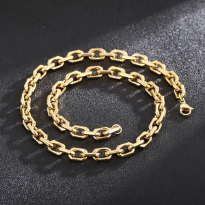 Polished 18K gold plated stainless steel cable chain necklace on a black textured background