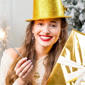 Close-up of red and white Christmas candy cane earrings with a silver bow on a model