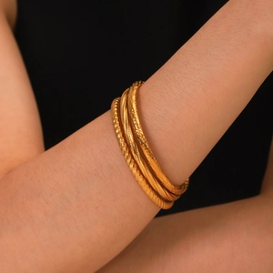 Classic gold stainless steel hollow textured bangles set for women in minimalist style