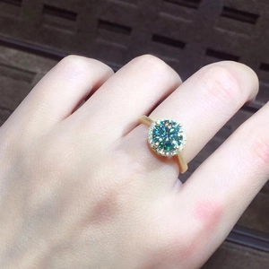 3-carat blue-green moissanite halo ring with gold plating and paved diamond accents