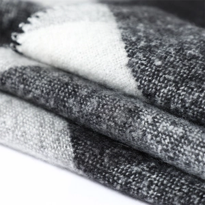 Macro shot showing black and white checkered cashmere texture and soft woven fabric detail