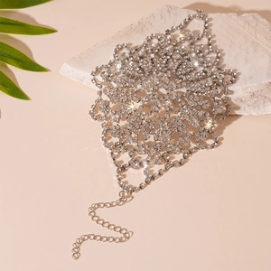 Luxury rhinestone floral body chain in silver finish on natural stone background