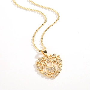 Gold MOM heart pendant necklace with shimmering crystals and a hollow heart border