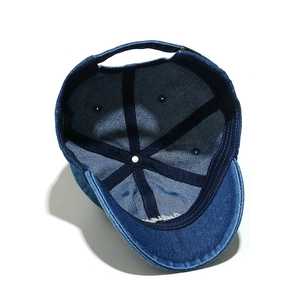 Inside view of denim baseball cap showing reinforced stitching and metal buckle