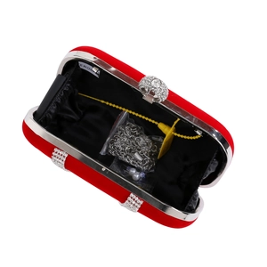 Detailed interior of red velvet clutch with silver chain strap and rhinestone clasp