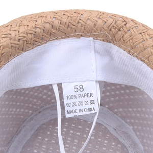 Internal view of straw jazz hat showing white sweatband and 100% paper material label