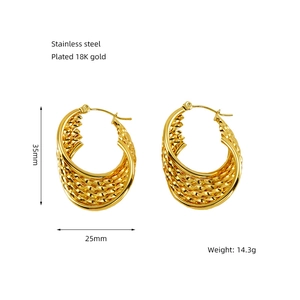 Macro detail of gold-plated stainless steel hoop earrings with woven rope texture