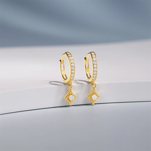 Detail of S925 silver gold-plated hoop earrings with diamond-set rhombus pendant