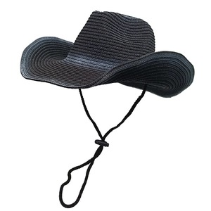 Detail of black woven straw cowboy hat with wide brim and adjustable wind cord