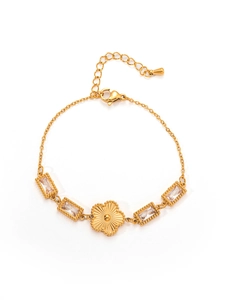 Detail of vintage gold bracelet showing emerald-cut zircons and a central flower motif