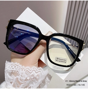 Macro detail of square photochromic sunglasses frame with metal hinges and size specs