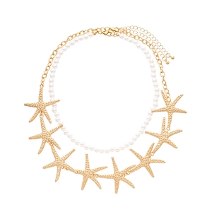 Two-layer ocean style necklace with white faux pearls and golden starfish charms
