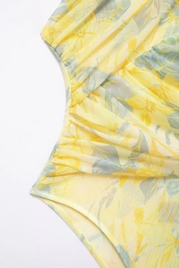 Detail of floral mesh fabric with side ruching and delicate stitching on bodysuit