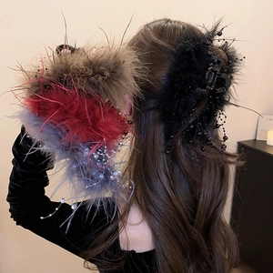 Detail showing plush feather hair claws with elegant glass beads in four colors