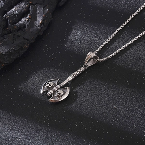 Detailed view of punk style double-headed axe pendant with skull engraving in silver steel