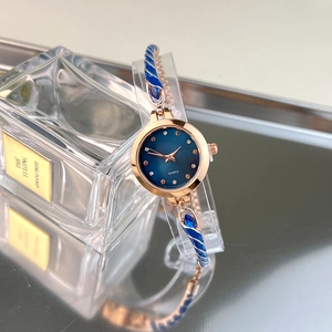 Detail of rose gold ladies' bracelet watch with blue enamel and crystal accents