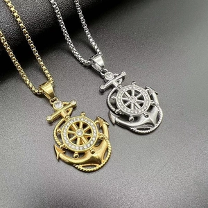 Macro shot of gold and silver anchor necklaces with rhinestones on black background
