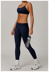 Full-body shot of navy blue high-waisted yoga set featuring sports bra and slim leggings