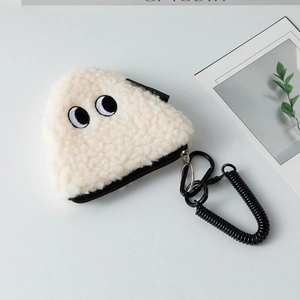 Close-up of a white sherpa coin purse with cute eye embroidery and black spring lanyard