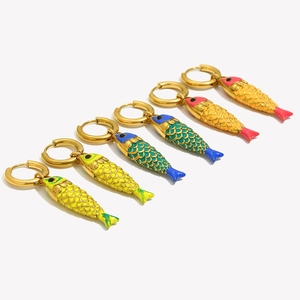 Detail of 18K gold plated hoop earrings with colorful enamel fish pendants in three colors