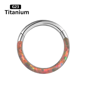 Close-up of G23 titanium septum ring featuring inlaid vibrant orange fire opal stones