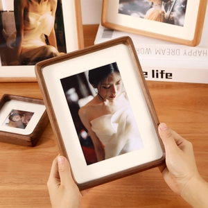 Solid black walnut photo frame with rounded corners and elegant wood grain texture