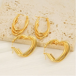 Close-up of 18k gold plated stainless steel heart and oval multi-layered hoop earrings