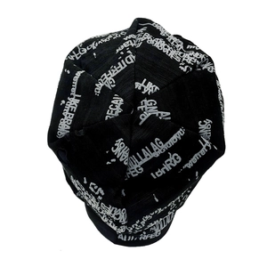 Detail of black knitted beanie with distressed aesthetic and white letter pattern