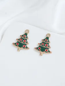 Detail of green enamel Christmas tree charms with red dots and metal hanging loops