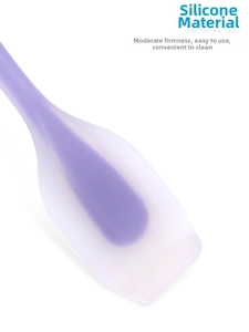 Detail of purple silicone spatula with ergonomic core and easy-to-clean translucent finish