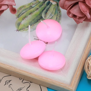Three pink floating tea light candles with cotton wicks for wedding decor